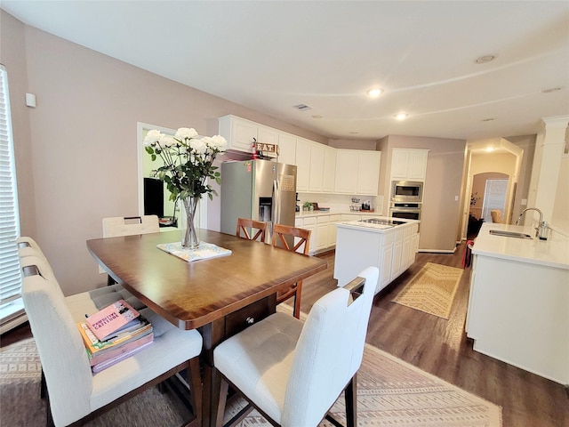 dining area with sink and dark hardwood / wood-style floors