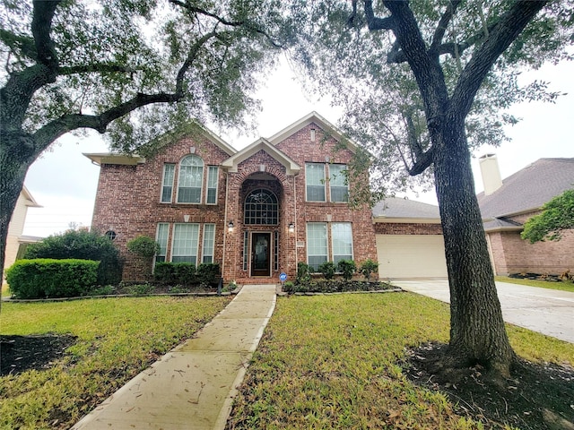 view of property with a garage and a front yard