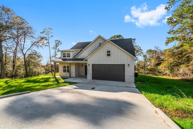 modern inspired farmhouse featuring a garage and a front yard