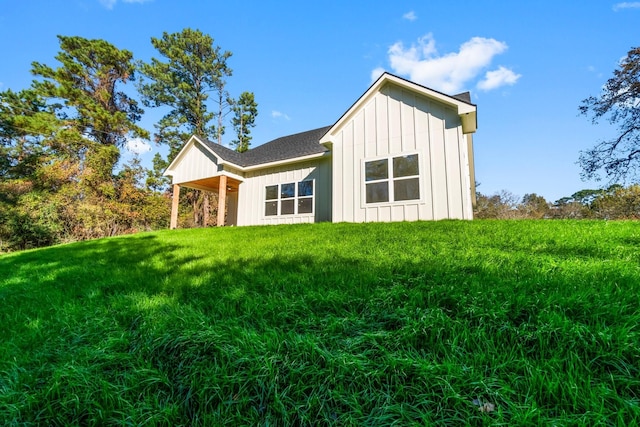 rear view of house featuring a yard