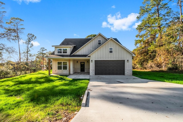 modern inspired farmhouse featuring a garage and a front yard