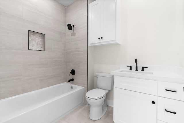 full bathroom featuring vanity, tile patterned flooring, tiled shower / bath combo, and toilet