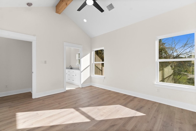 interior space with ceiling fan, a healthy amount of sunlight, beam ceiling, and light hardwood / wood-style flooring