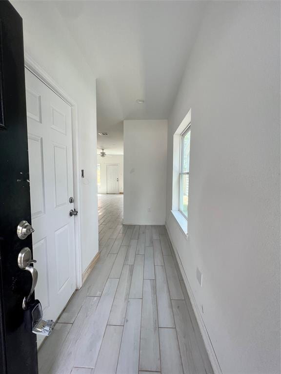 hall with light hardwood / wood-style flooring