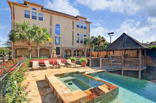 view of pool with a gazebo, an in ground hot tub, and a patio area