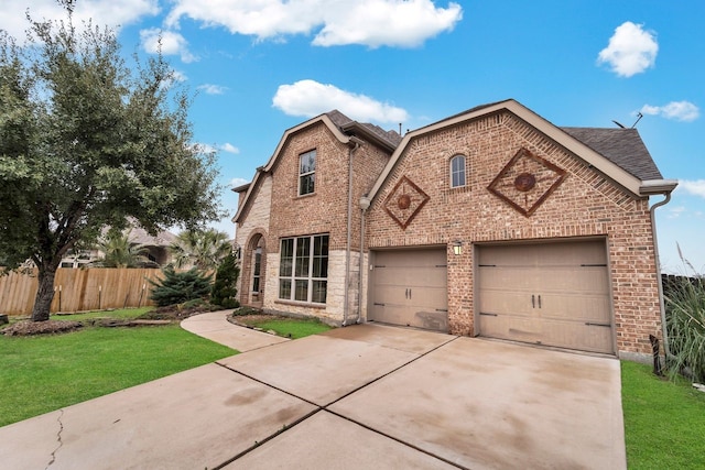 view of front of property featuring a garage and a front lawn