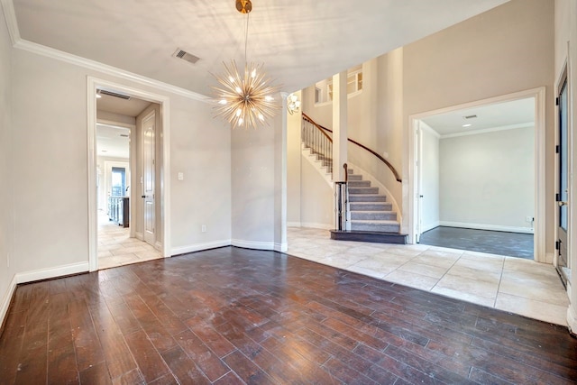 interior space featuring an inviting chandelier, hardwood / wood-style floors, and crown molding