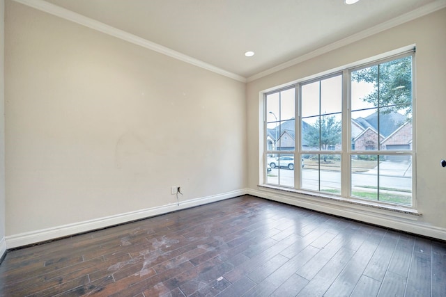 spare room featuring dark wood-type flooring and ornamental molding