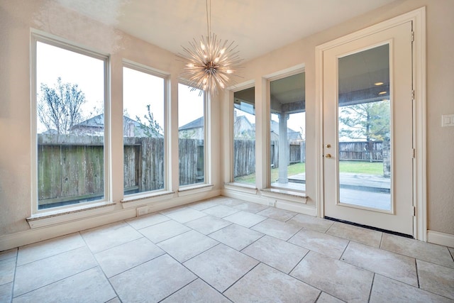 unfurnished sunroom with a chandelier