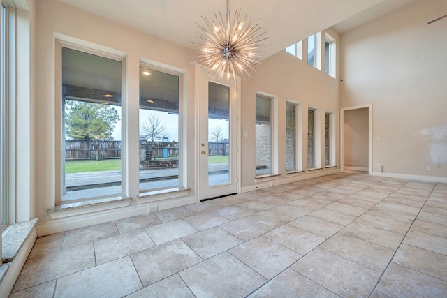 unfurnished room with an inviting chandelier and a wealth of natural light