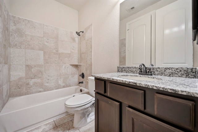 full bathroom with vanity, toilet, and tiled shower / bath combo