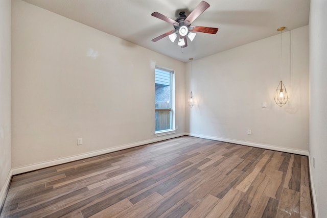 spare room featuring dark hardwood / wood-style floors and ceiling fan