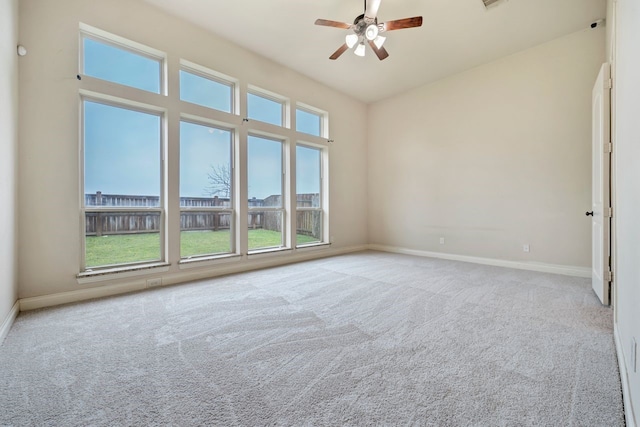 carpeted empty room featuring ceiling fan