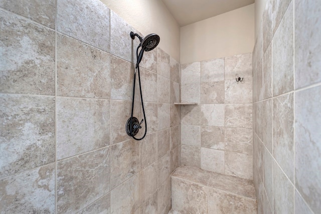 interior details with a tile shower