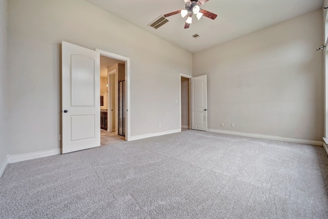 unfurnished bedroom featuring light colored carpet and ceiling fan