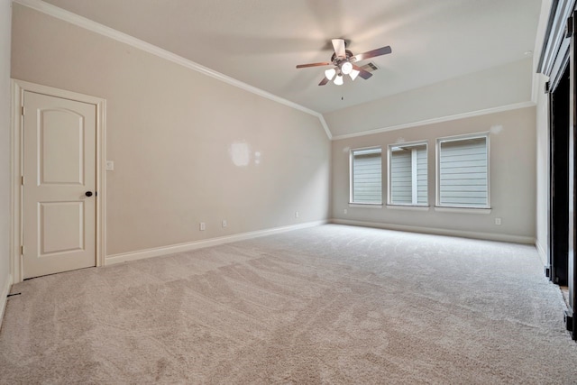 carpeted empty room featuring lofted ceiling, crown molding, and ceiling fan