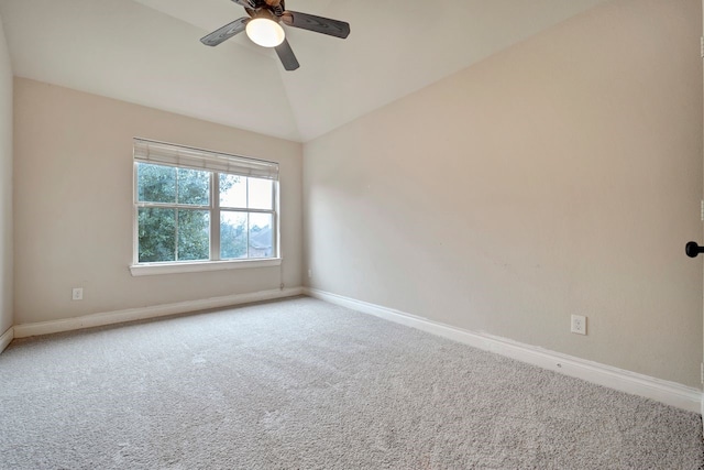 empty room with lofted ceiling, carpet floors, and ceiling fan