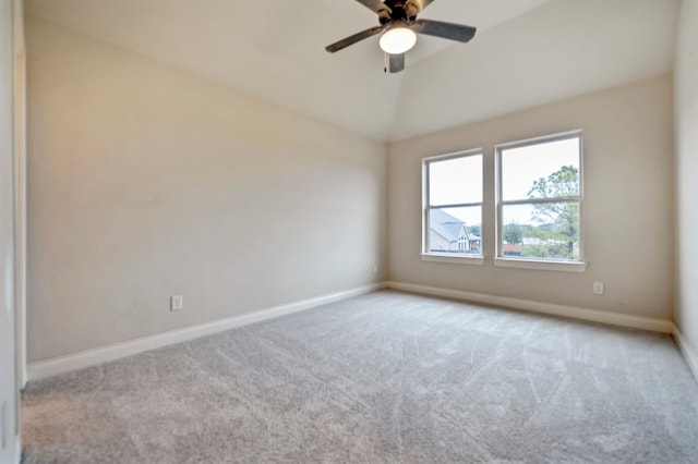 carpeted empty room featuring lofted ceiling and ceiling fan