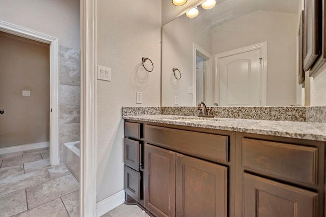 bathroom with vanity and a tub