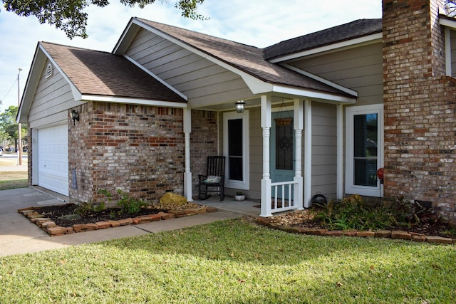 view of front facade with a garage, a front yard, and a porch