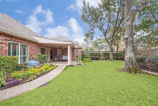 view of yard featuring a patio and ceiling fan