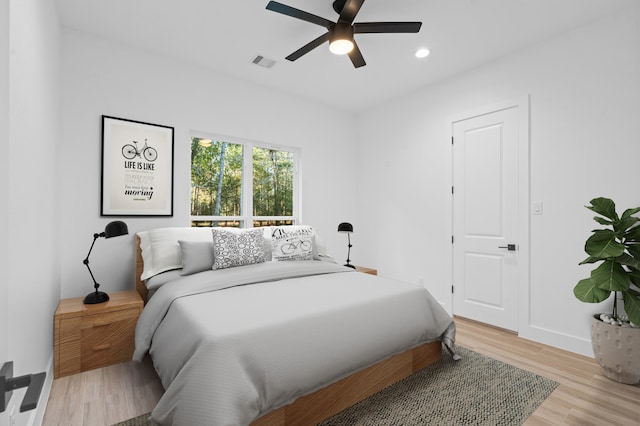 bedroom with ceiling fan and light hardwood / wood-style flooring