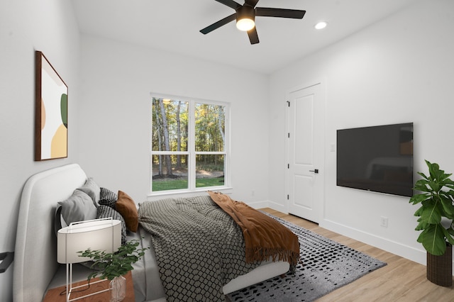 bedroom with ceiling fan and light hardwood / wood-style floors