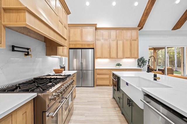 kitchen featuring light brown cabinetry, sink, custom range hood, beamed ceiling, and stainless steel appliances