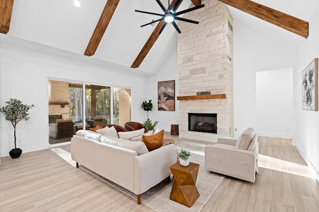 living room with light hardwood / wood-style flooring, a fireplace, high vaulted ceiling, and beamed ceiling