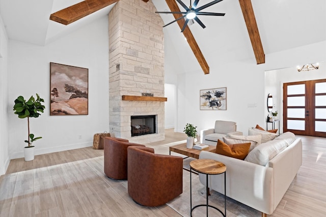 living room featuring a stone fireplace, high vaulted ceiling, french doors, and beamed ceiling