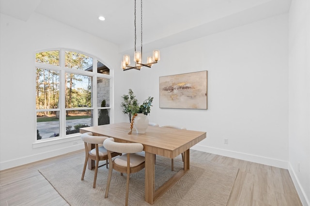 dining area with a chandelier and light hardwood / wood-style floors