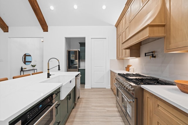 kitchen featuring sink, custom exhaust hood, dishwasher, beamed ceiling, and range with two ovens