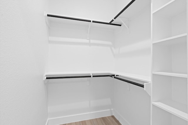 spacious closet with light hardwood / wood-style floors