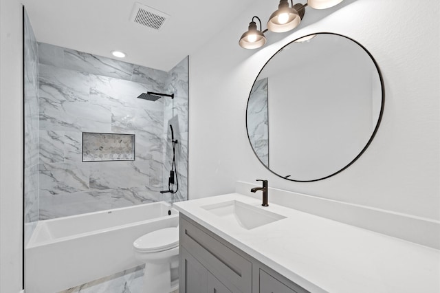 full bathroom with vanity, tiled shower / bath combo, and toilet