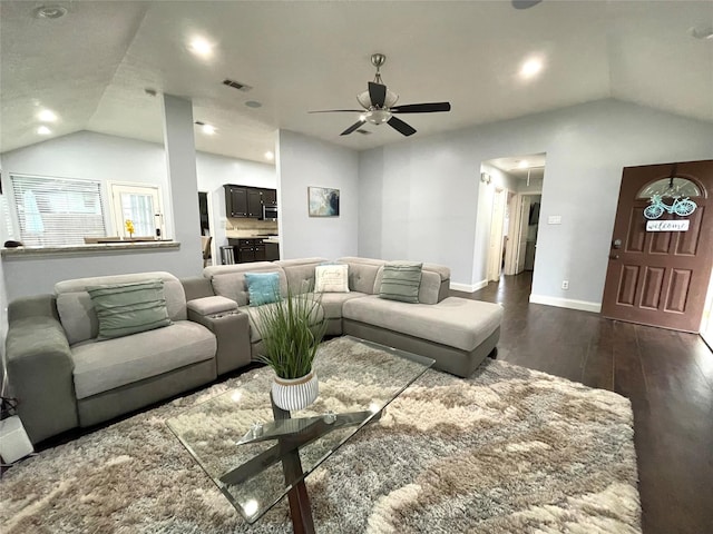 living room featuring dark hardwood / wood-style flooring, vaulted ceiling, and ceiling fan