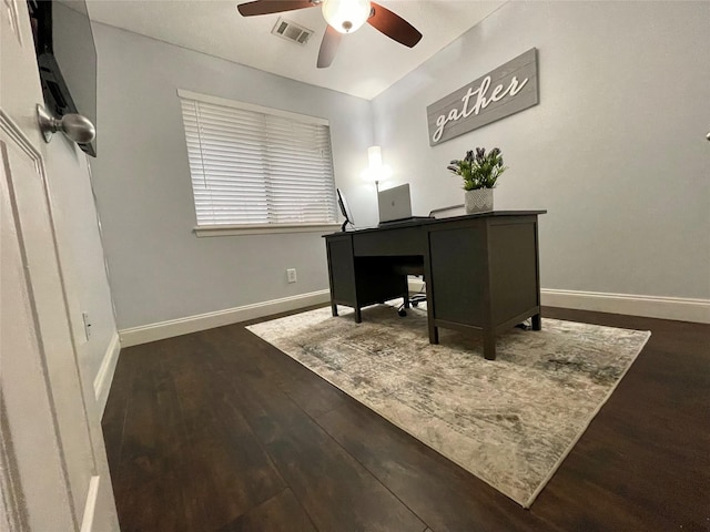 home office with dark hardwood / wood-style flooring and ceiling fan