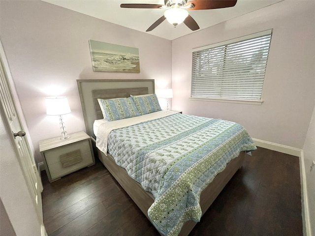 bedroom with dark hardwood / wood-style floors and ceiling fan