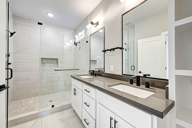 bathroom featuring vanity, tile patterned flooring, and a shower with door