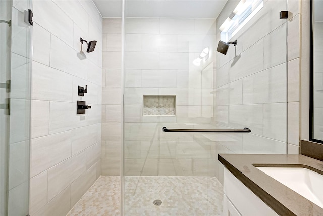 bathroom featuring vanity and an enclosed shower