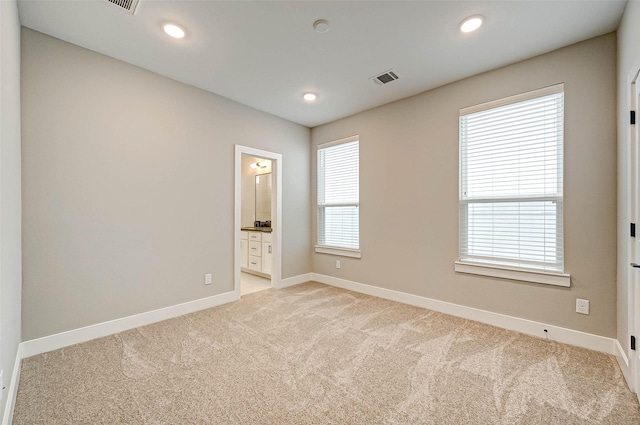 empty room featuring light colored carpet