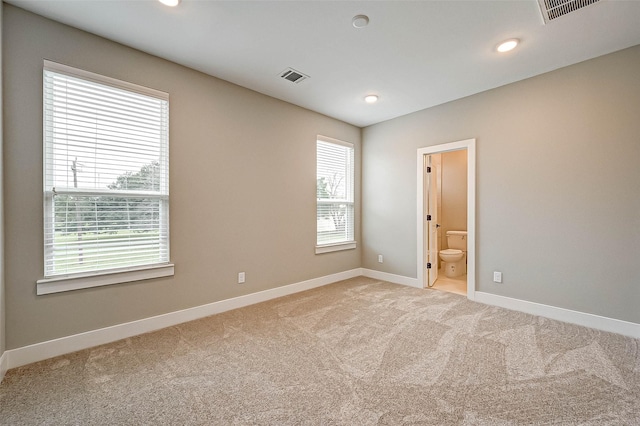 carpeted empty room with plenty of natural light