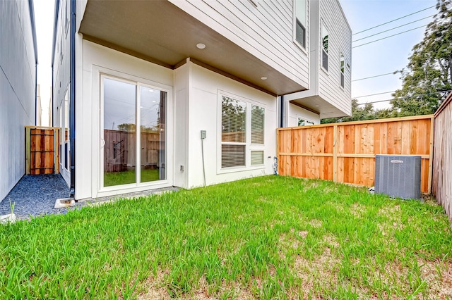 exterior space featuring central AC and a lawn