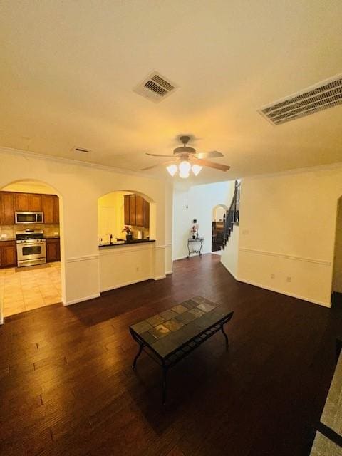 living room featuring crown molding, ceiling fan, and light wood-type flooring