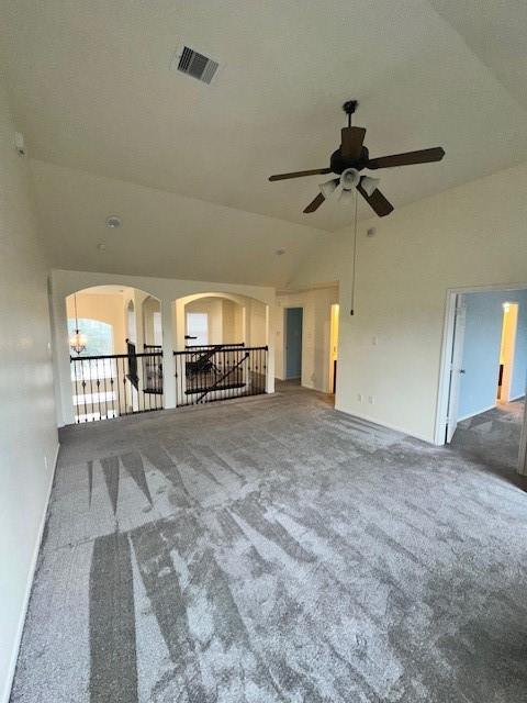 unfurnished living room featuring vaulted ceiling and carpet flooring