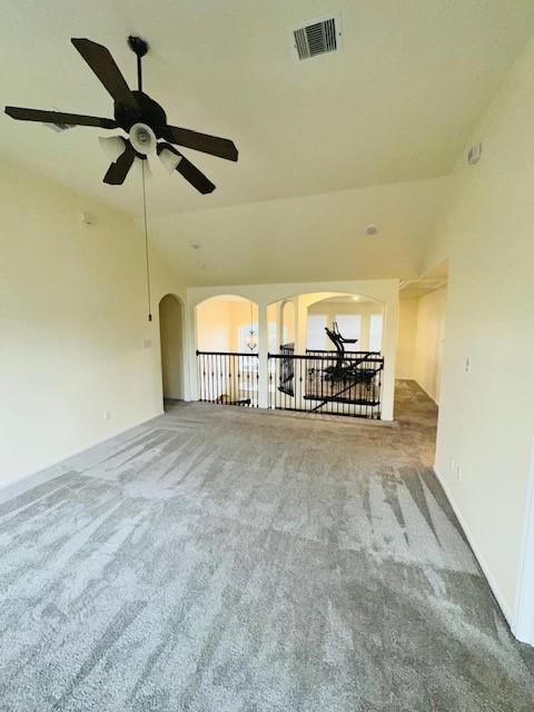 unfurnished living room featuring carpet and lofted ceiling