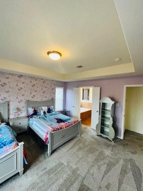 carpeted bedroom with connected bathroom