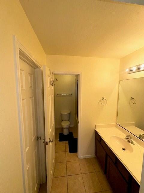 bathroom featuring tile patterned flooring, vanity, and toilet