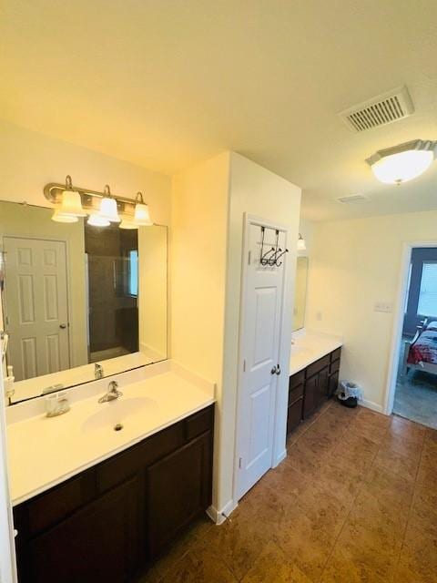 bathroom with vanity and a shower with shower door