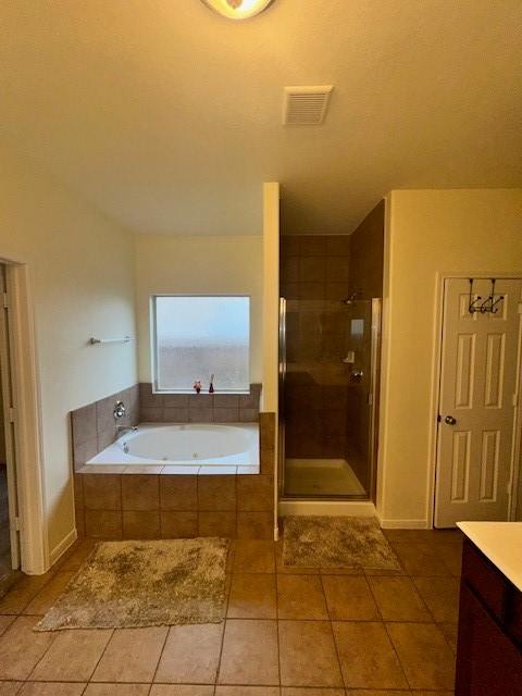 bathroom featuring vanity and plus walk in shower