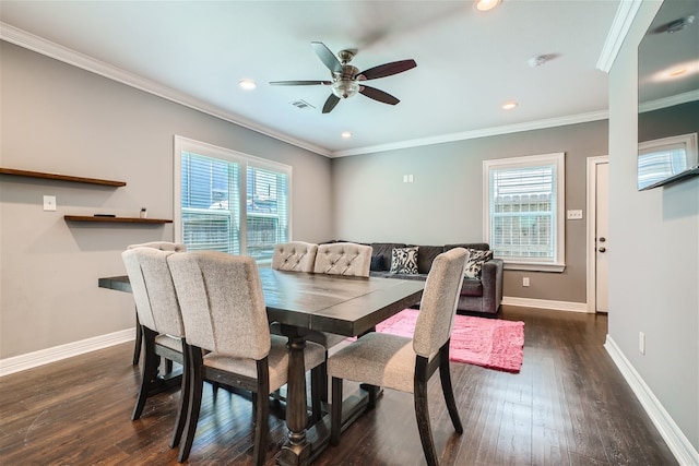 dining room with crown molding, plenty of natural light, and dark hardwood / wood-style floors